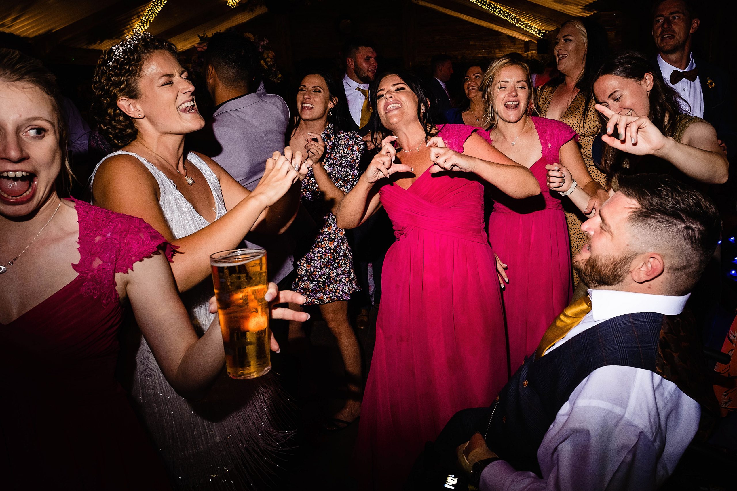 a lively wedding dance floor with a crowd surrounding the couple. woodstock weddings and events wedding photography by emma and rich