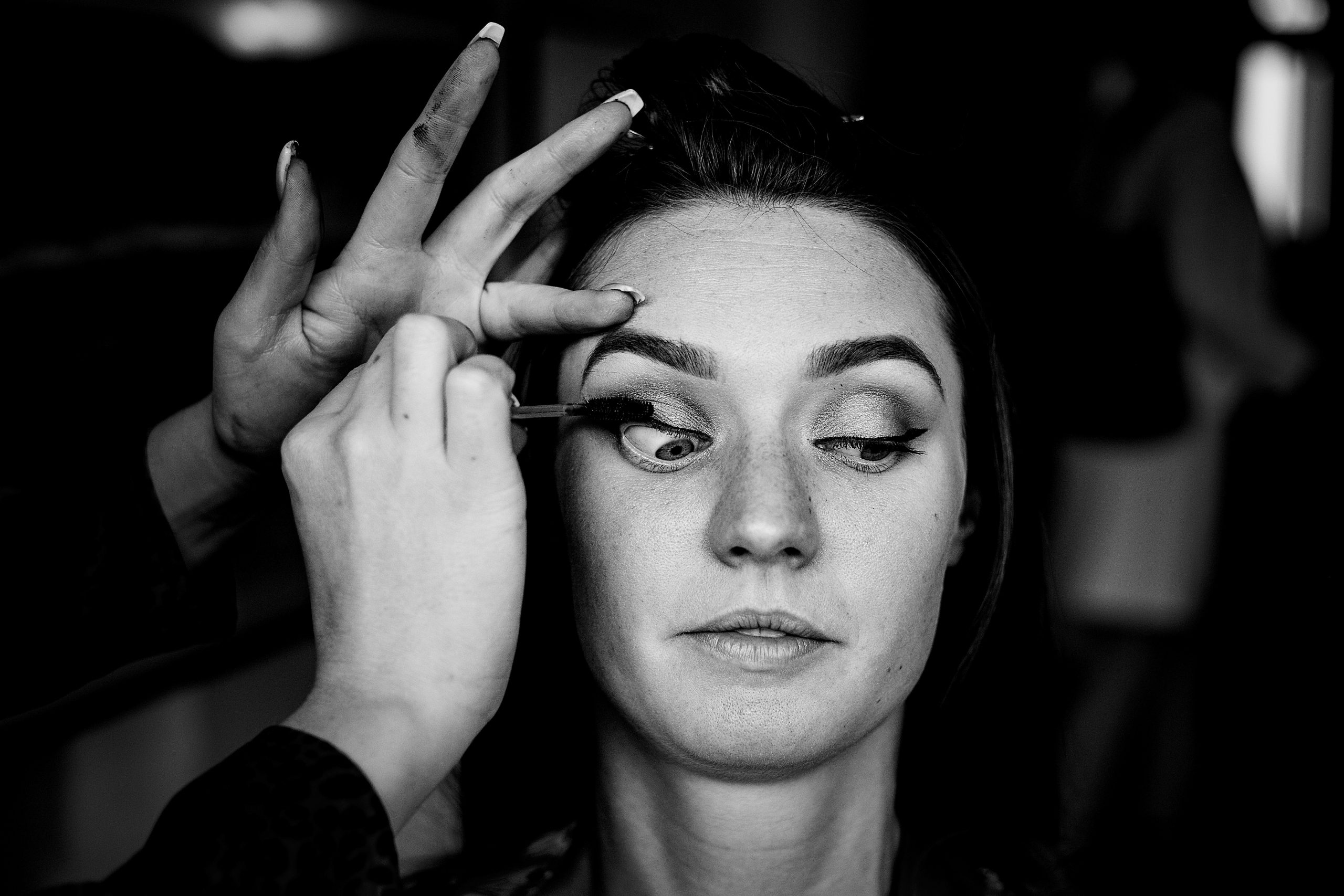 a woman's eyelid being comically stretched as mascara is applied. rangefinder 30 rising stars emma and rich.