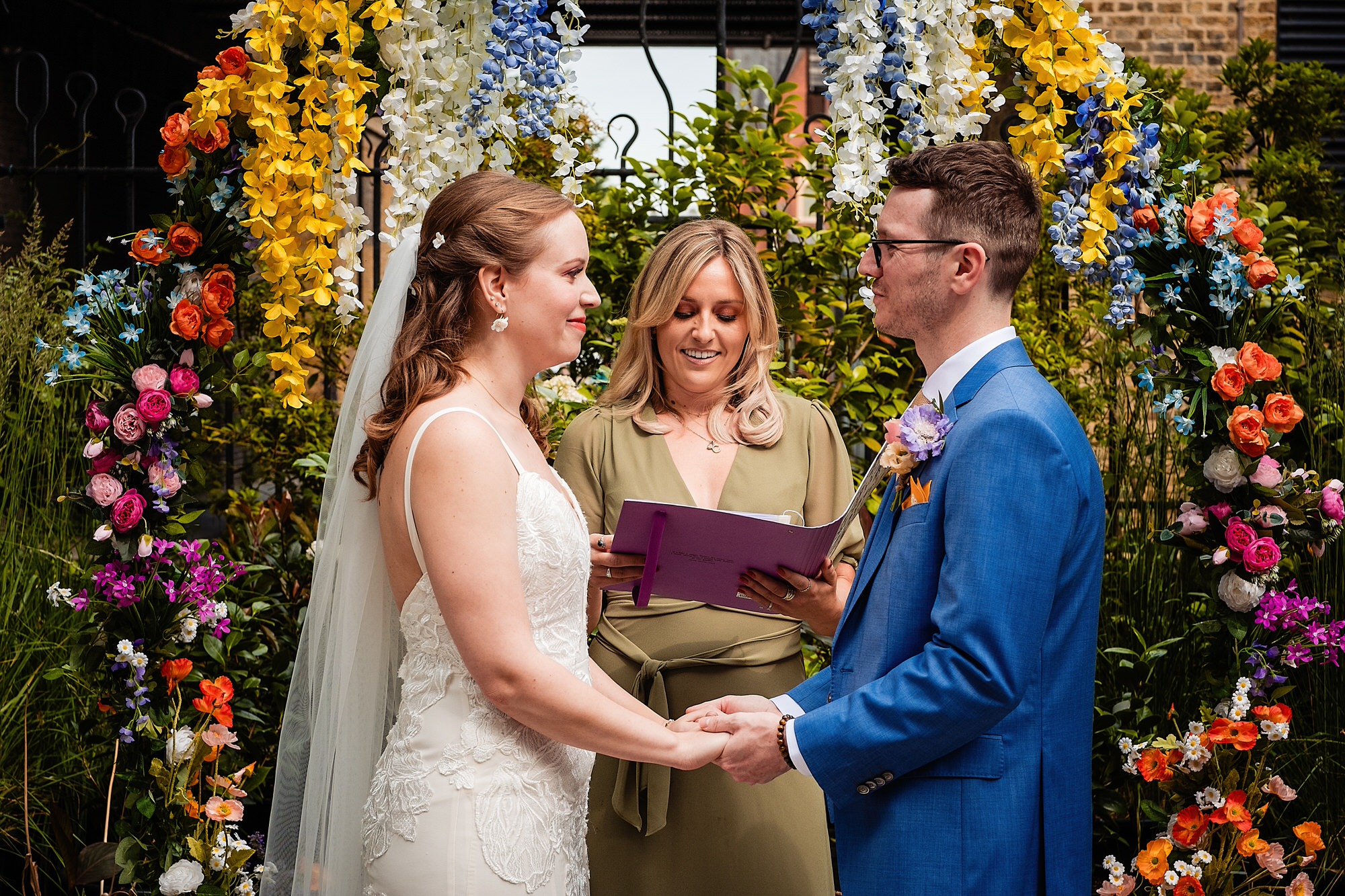 a bride and groom face each other during an outdoors wedding ceremony. museum of the home wedding photography by emma and rich.